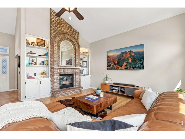 Property Photo 11 Striking double-sided brick fireplace that connects the family and living rooms.(20' x 15')