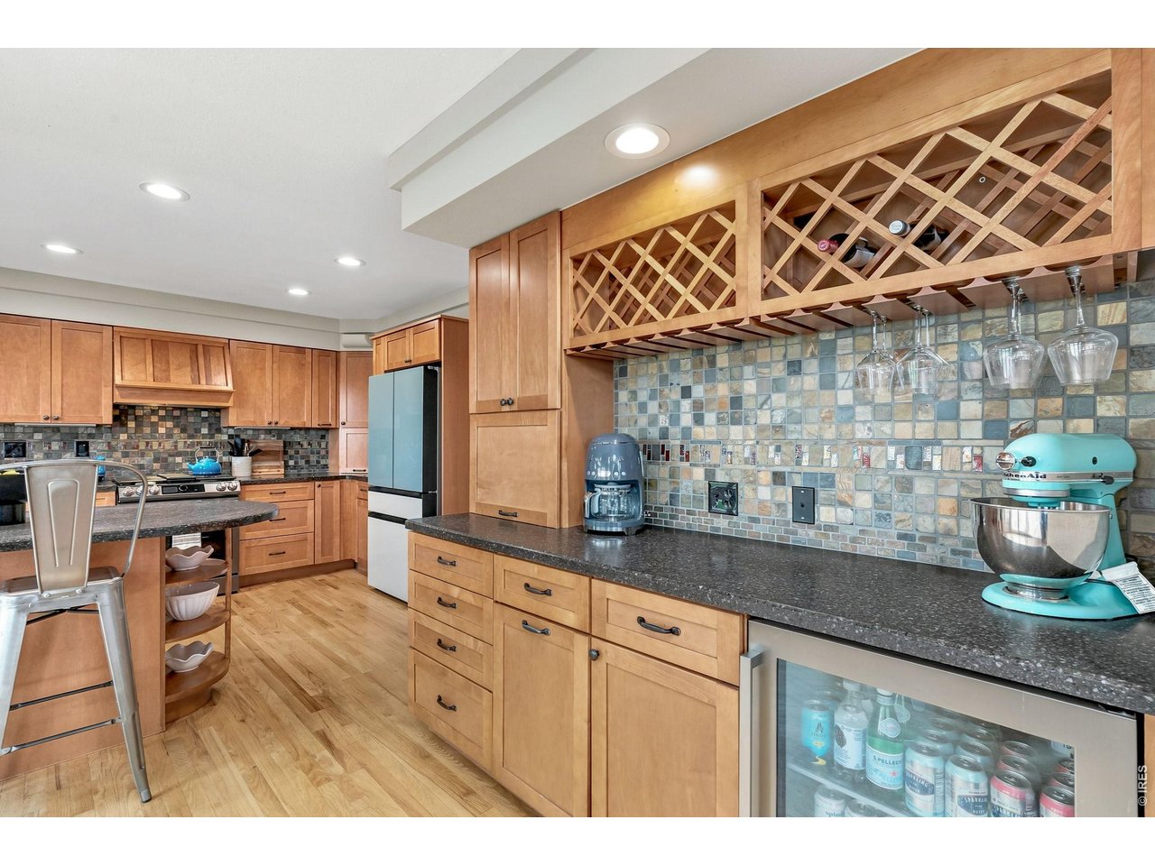 Property Photo 15 Built-in dry bar with wine rack and beverage fridge off the kitchen perfect for entertaining.