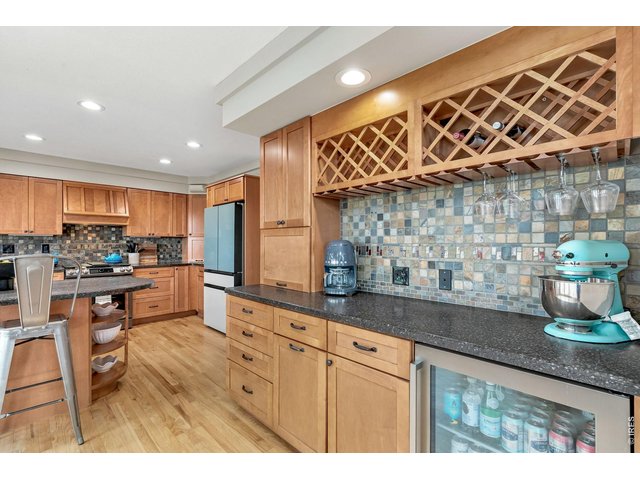 Property Photo 15 Built-in dry bar with wine rack and beverage fridge off the kitchen perfect for entertaining.