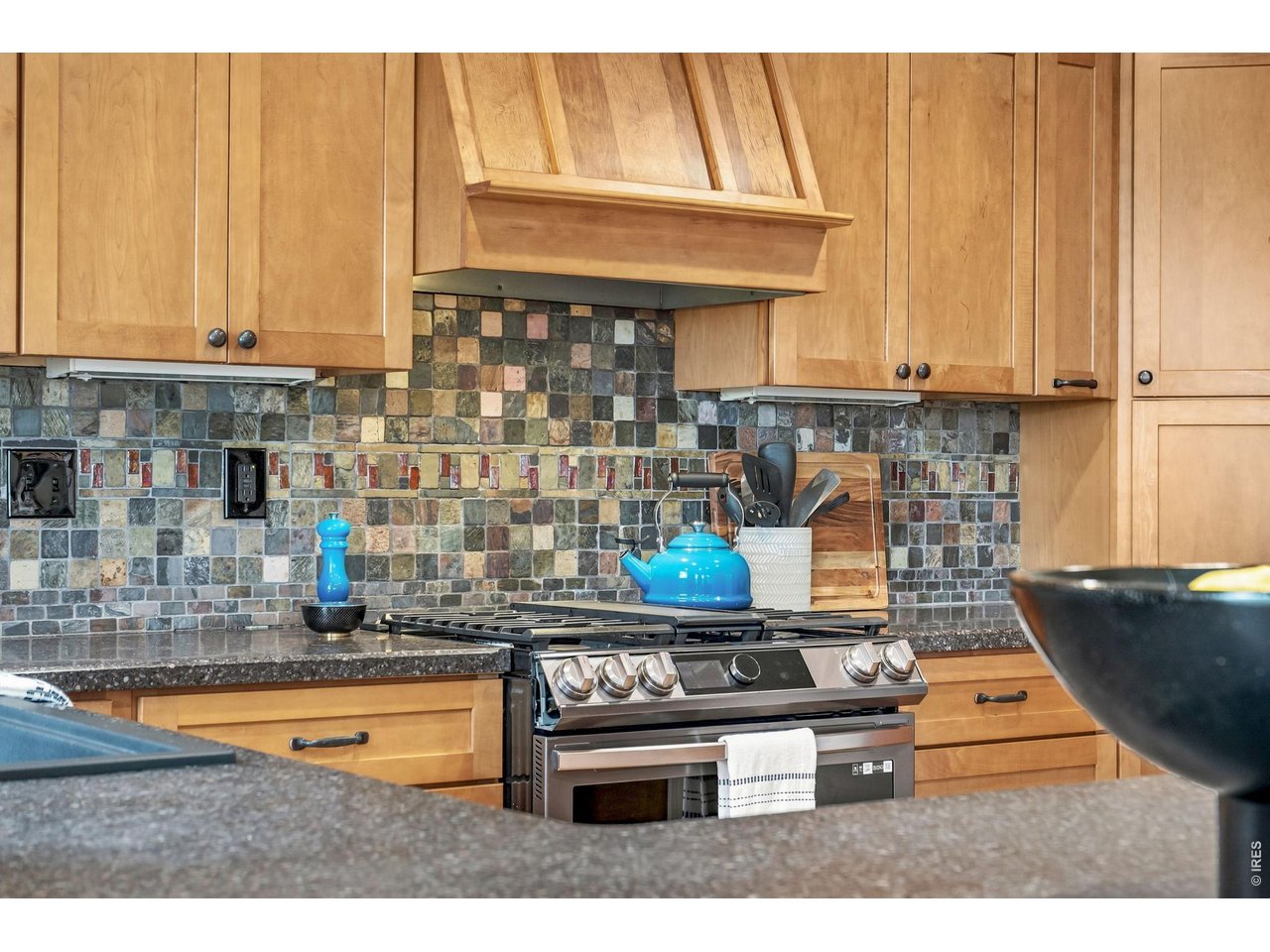 Property Photo 18 New stainless steel gas range with updated cabinetry.