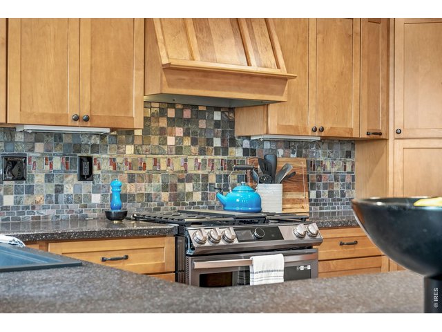 Property Photo 18 New stainless steel gas range with updated cabinetry.