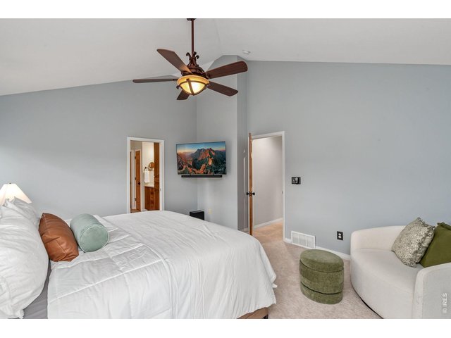 Property Photo 22 Primary bedroom on upper level with vaulted ceilings. (16' x 14')