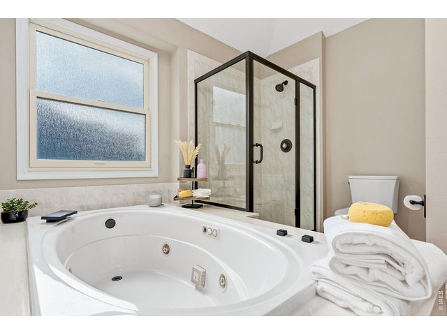 Property Photo 25 Updated en-suite primary bathroom with soaking tub.