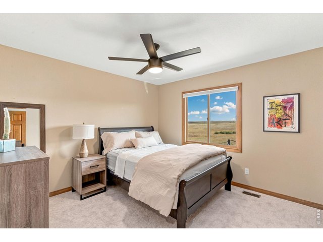 Property Photo 28 Secondary bedroom on upper level with views of open space. (12' x 12')