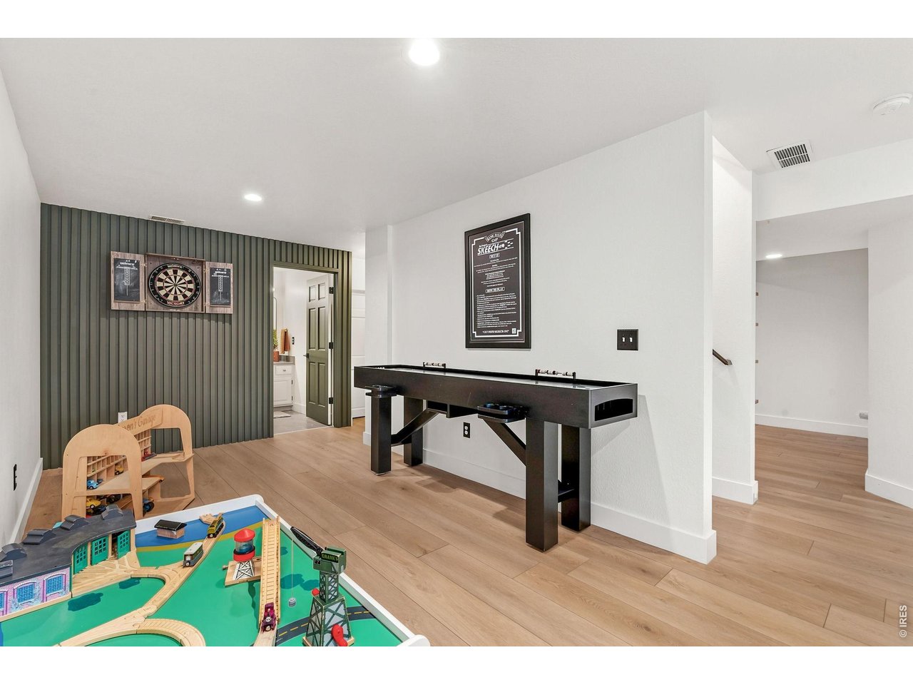 Property Photo 33 Game room area with dart board and Skeech table. Rec room in basement. (30' x 15')