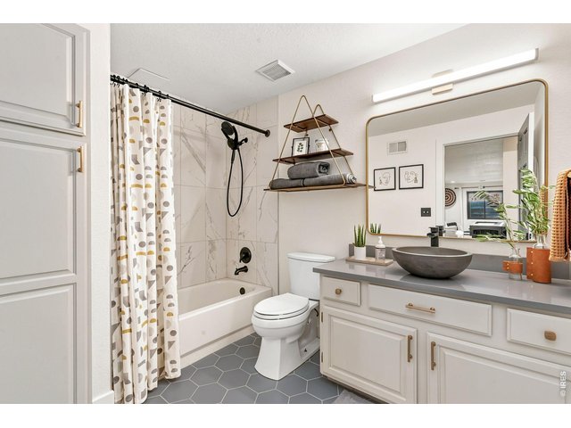 Property Photo 34 Newly updated full basement bathroom with tile and quartz vanity.