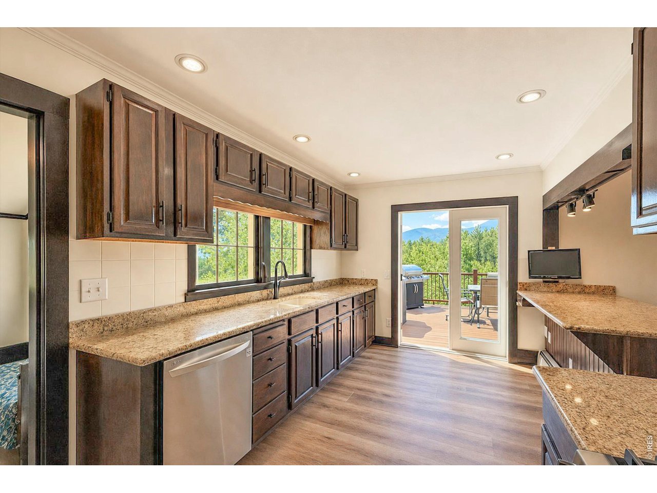 Property Photo 8 kitchen opens to large deck with skyline views