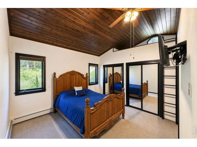 Property Photo 26 primary suite offers views of Mt. Meeker, vaulted wood ceilings and a loft