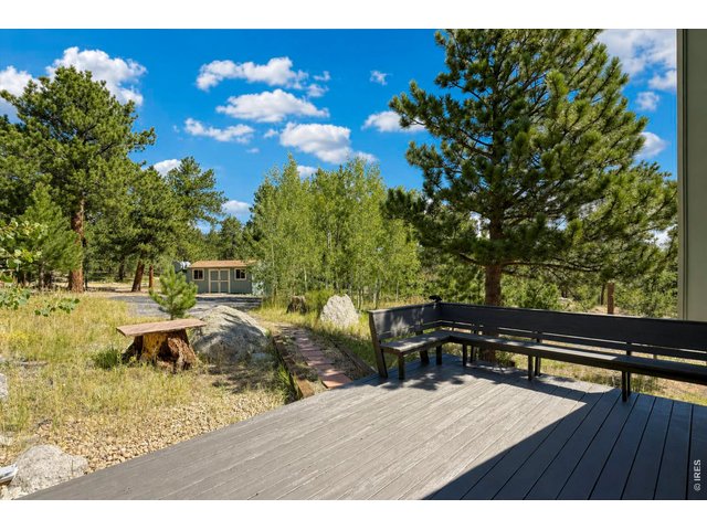 Property Photo 34 Deck from upstairs loft across second paved access and storage building