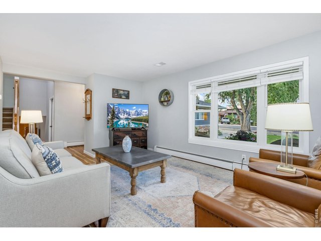 Property Photo 7 Large windows flood the living area with natural sunlight.