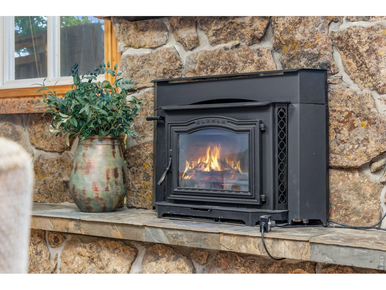 Property Photo 25 Cozy stone wood-burning fireplace creates a warm gathering space.