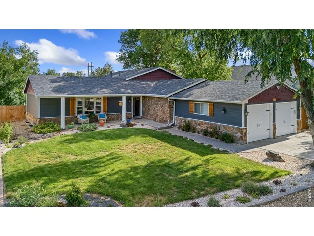 Property Photo 2 Situated on an expansive 1/3-acre lot with mature landscaping and inviting curb appeal.