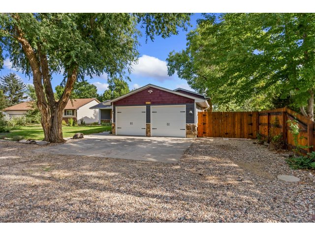 Property Photo 4 A rare attached 4-car tandem garage offers exceptional space for vehicles, storage, or hobbies.