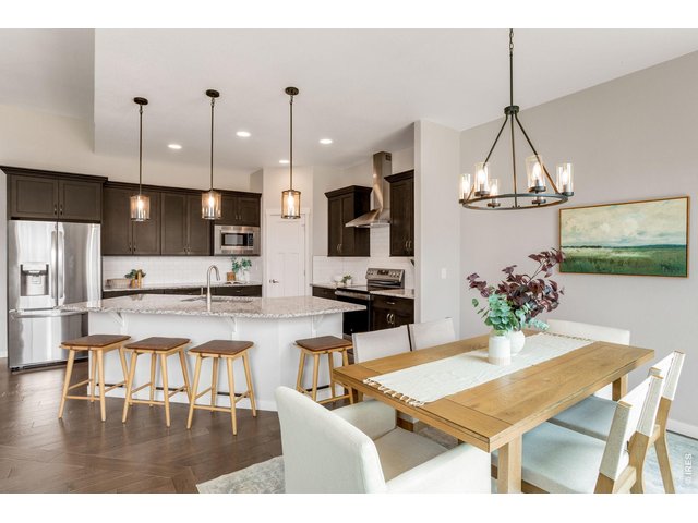 Property Photo 9 All stainless steel appliances, large hood, built-in microwave. Walk-in pantry & timless subway backsplash.