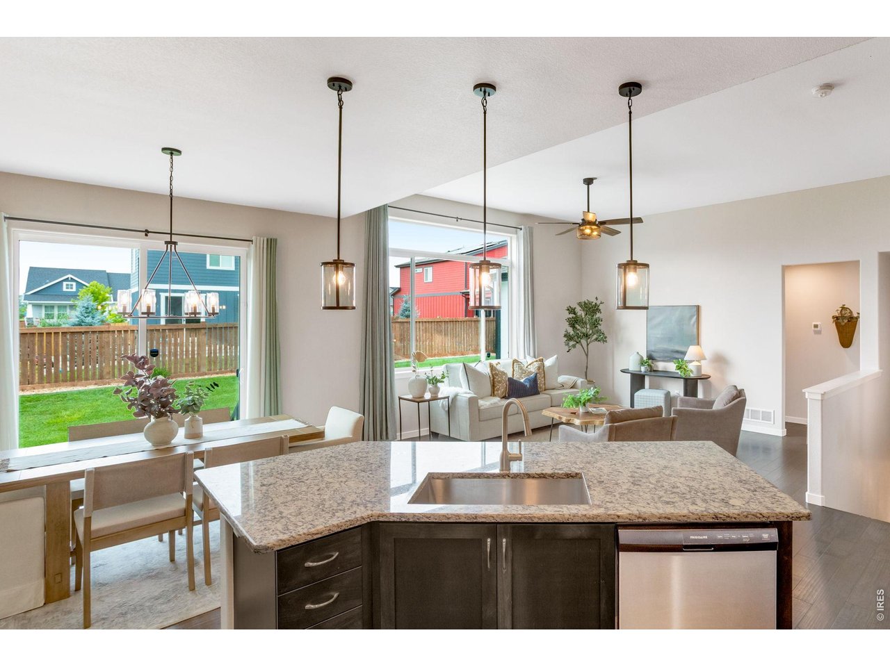 Property Photo 8 Expansive picture windows, oversized Granite island, pretty shaker style cabinetry. Bright and sunny, open concept easy living nearly 1,600 sqft on the main level.