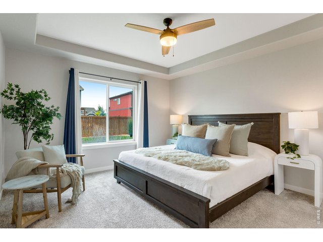 Property Photo 18 Primary Bedroom Suite, all bedrooms have ceiling fans and oversized picture windows.