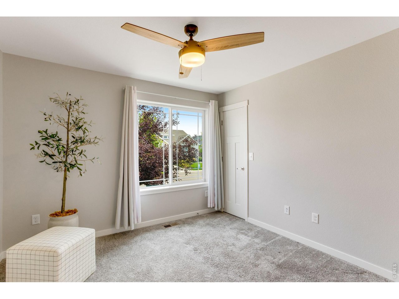 Property Photo 24 Secondary Bedroom main level walk-in closet, ceiling fan and oversized window