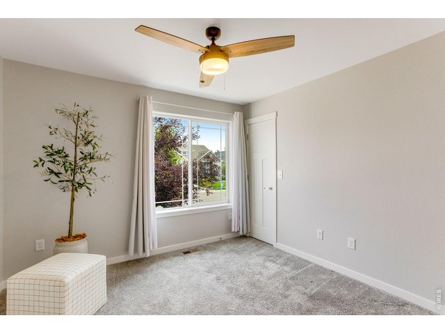 Property Photo 24 Secondary Bedroom main level walk-in closet, ceiling fan and oversized window