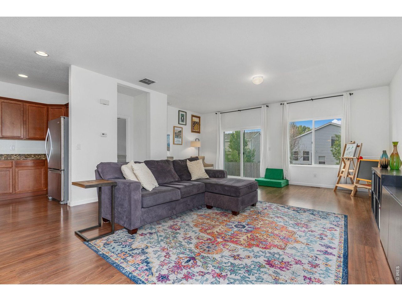 Property Photo 6 Neutral paint and well-kept hardwood floors bring warmth and energy into the home.