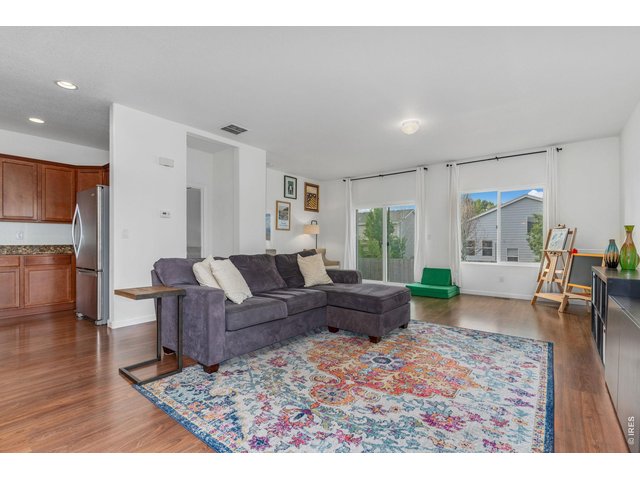 Property Photo 6 Neutral paint and well-kept hardwood floors bring warmth and energy into the home.