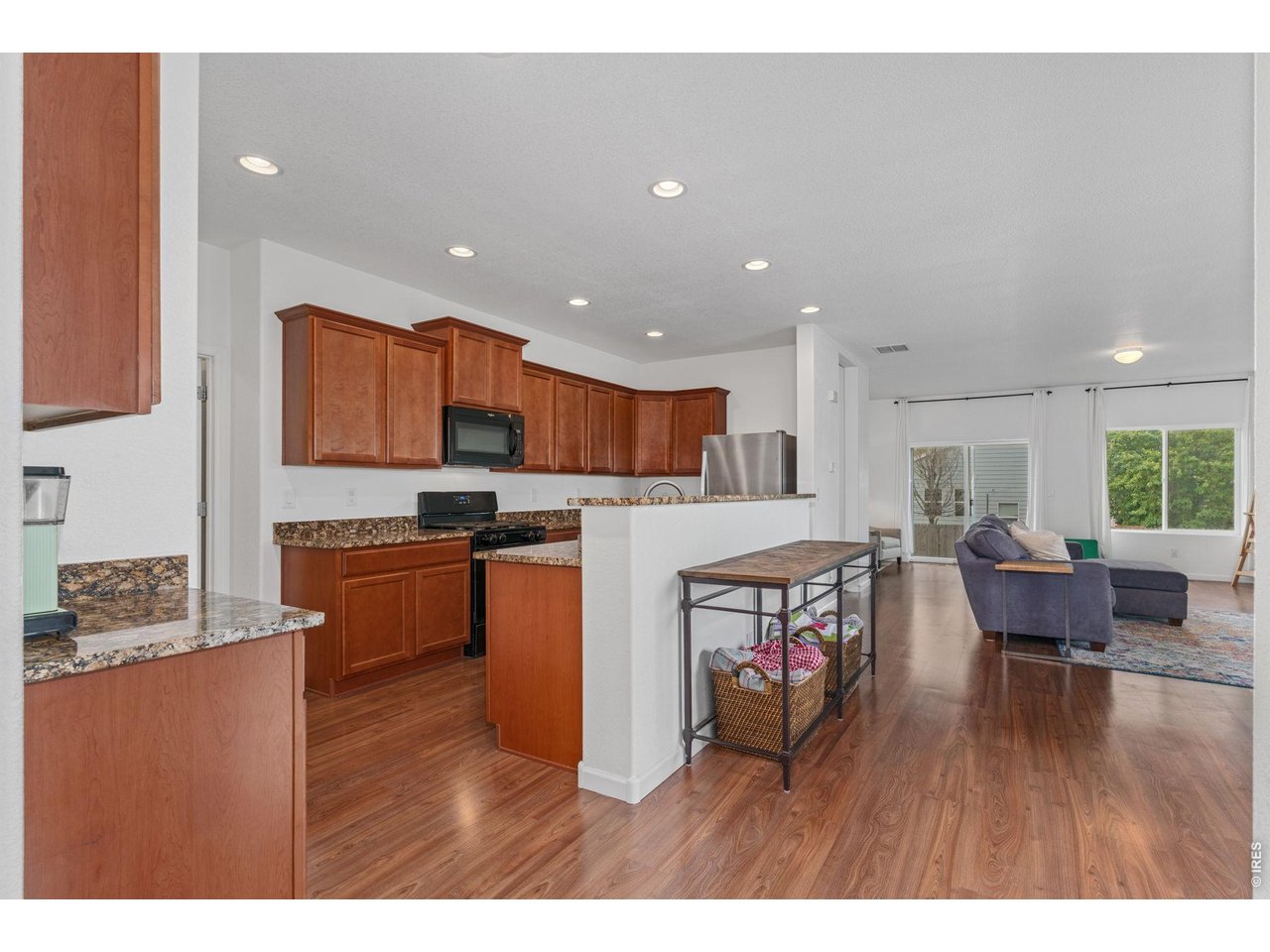Property Photo 8 The kitchen has plenty of cabinets and timeless neutral granite countertops.