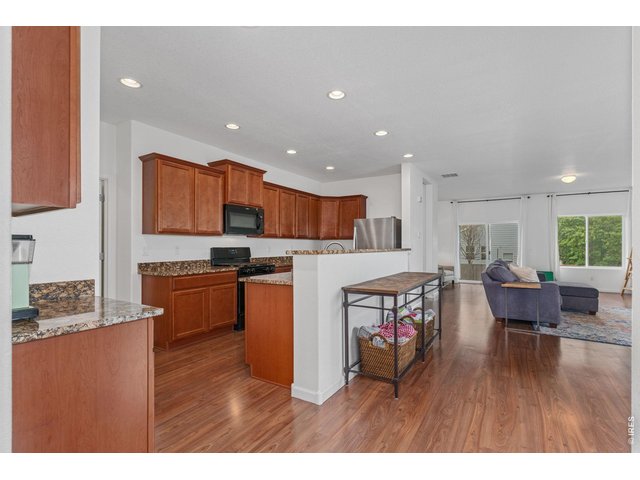 Property Photo 8 The kitchen has plenty of cabinets and timeless neutral granite countertops.