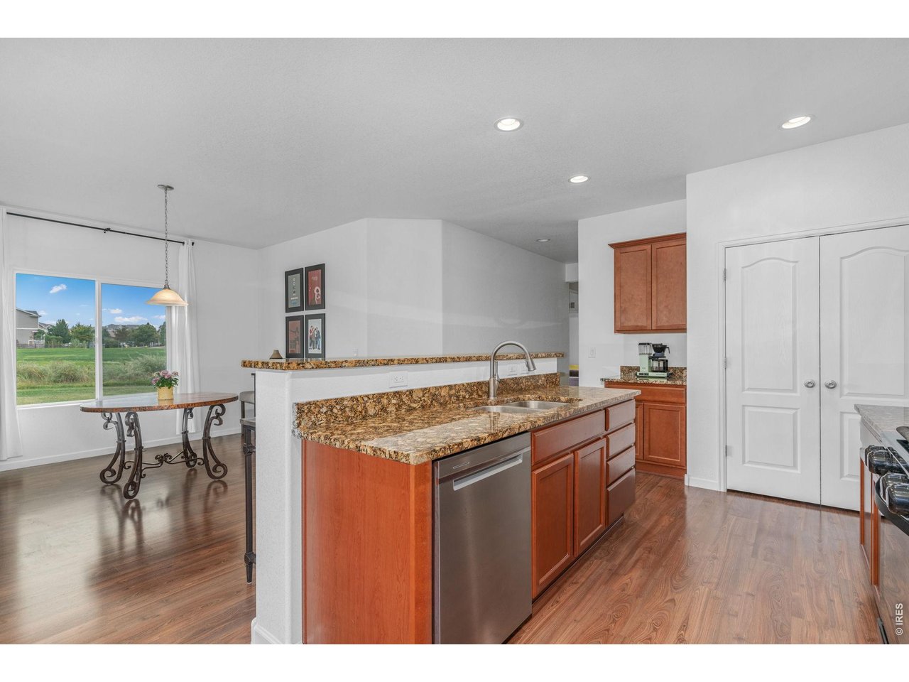 Property Photo 10 Stainless steel dishwasher and refrigerator, as well as an undermount sink and newly updated faucet, complete the kitchen space.