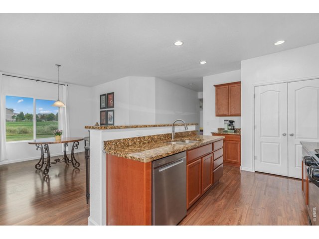 Property Photo 10 Stainless steel dishwasher and refrigerator, as well as an undermount sink and newly updated faucet, complete the kitchen space.