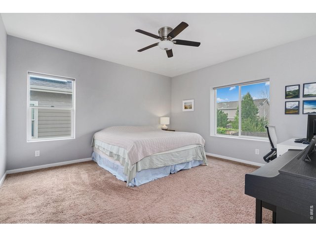 Property Photo 11 Large primary bedroom has views to the backyard and a ceiling fan for warm summer nights!