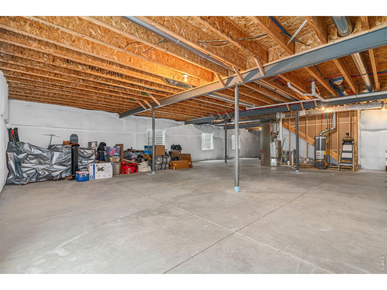 Property Photo 22 Large unfinished basement has 4 large windows and conviently tucked utilities which give you plenty of options if you choose to finish it.