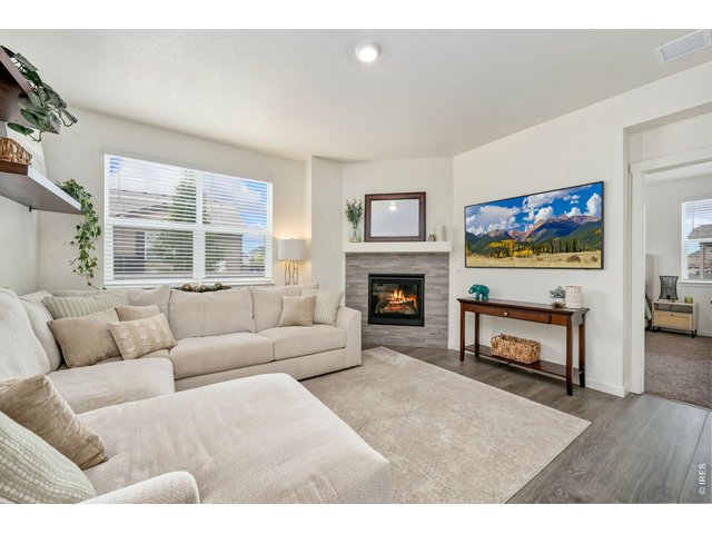 Property Photo 11 Living room with gas fireplace and mantle.
