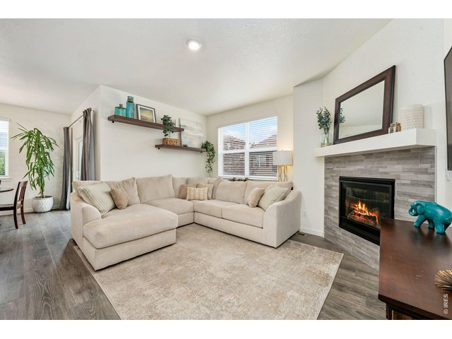 Property Photo 10 Living room features floating shelves and opens to kitchen.