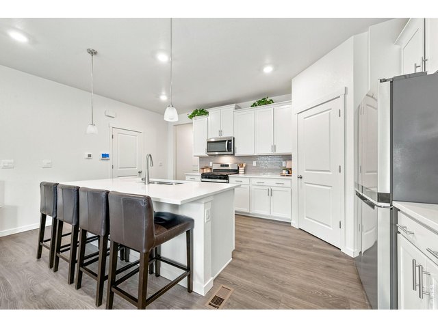 Property Photo 7 Kitchen offers center island with bar seating and huge pantry.
