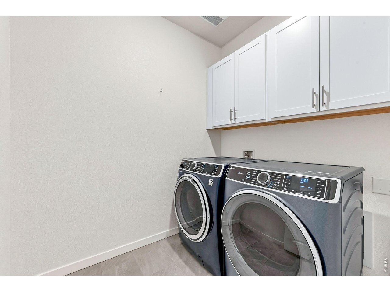 Property Photo 21 Main level laundry room with cabinetry. Washer & Dryer are excluded.