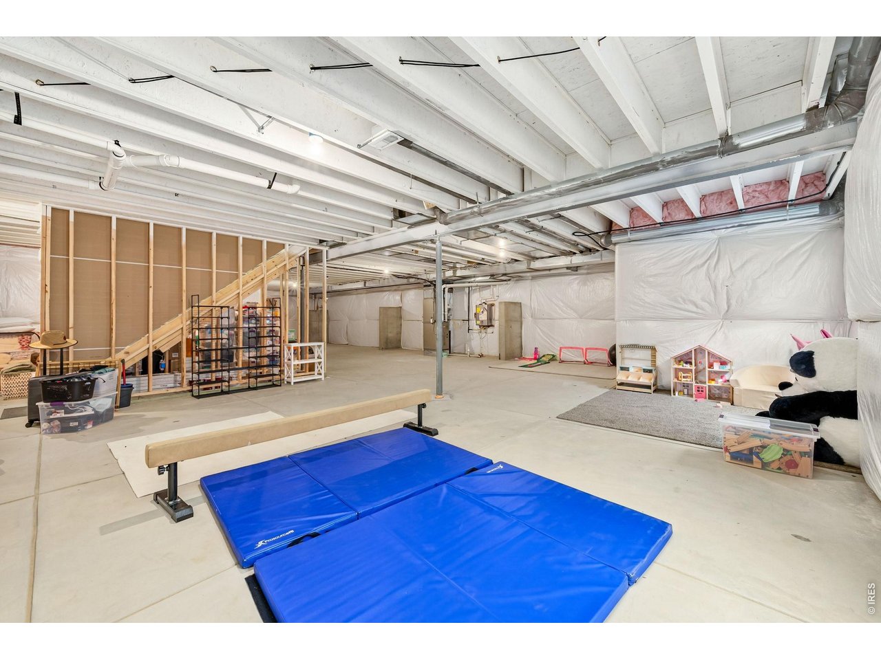 Property Photo 22 The sprawling unfinished basement offers 9' ceilings, tank-less water heater, and bathroom rough-in for your future expansion.