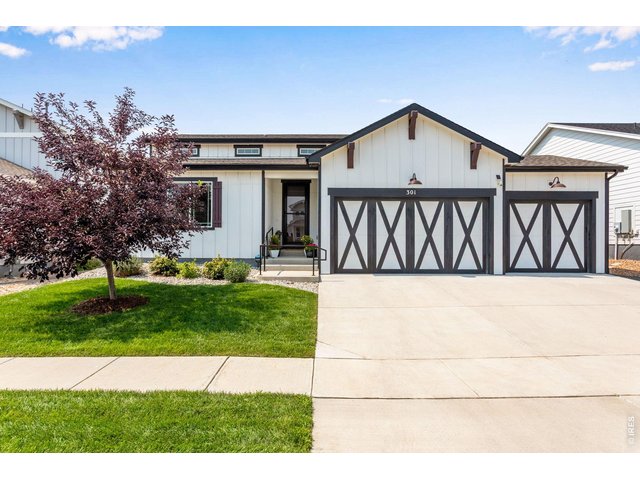 Property Photo 6 A practical 3-car garage, WiFi-enabled openers and a Simplisafe security system, from the moment you step through the oversized 8'-0" exterior doors, this home sets a tone of quiet sophistication.
