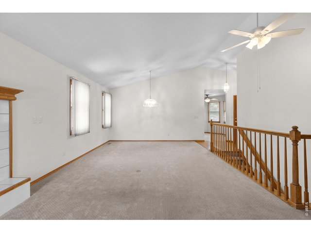 Property Photo 6 View from the back door into the living and dining rooms. Vaulted ceilings on the main level.