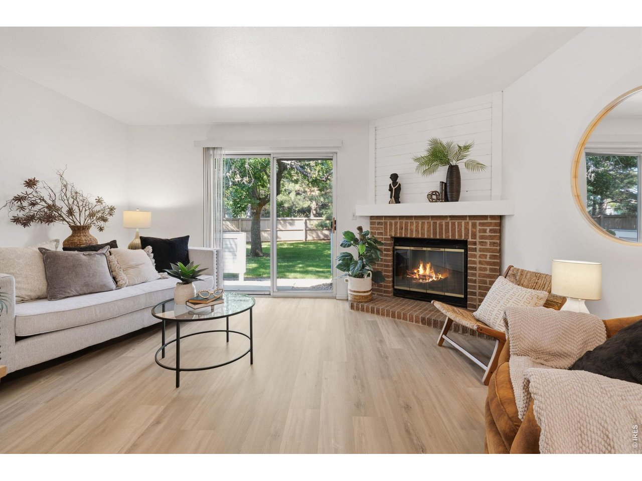 Property Photo 4 Inviting entertaining space with fireplace and brand new LVP flooring