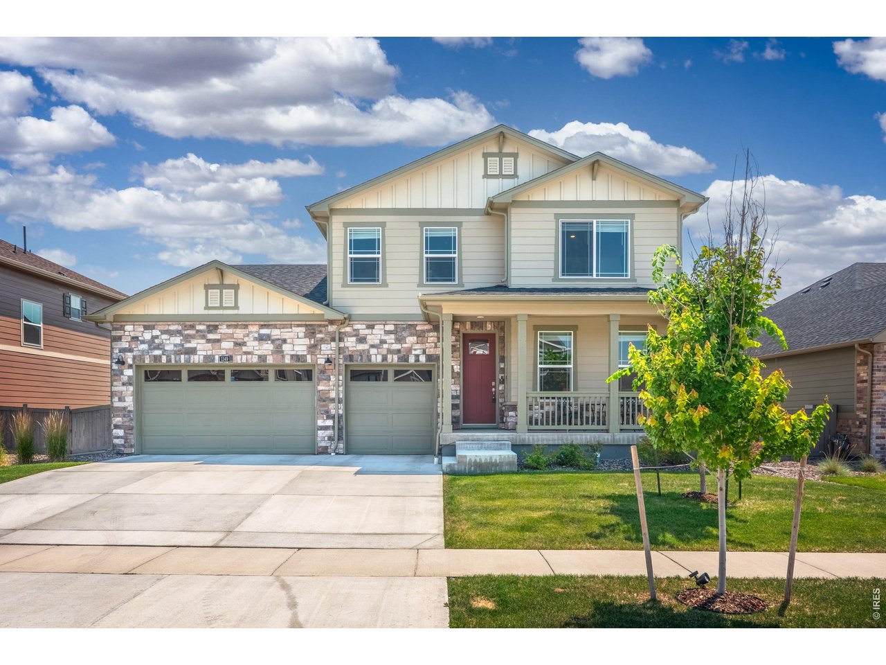 Property Photo 49 A two-story craftsman with stone accents, a 3-car garage, and a covered front porch.