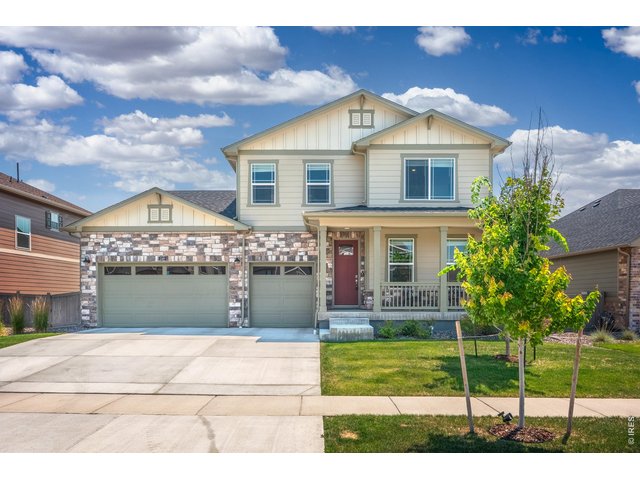 Property Photo 49 A two-story craftsman with stone accents, a 3-car garage, and a covered front porch.