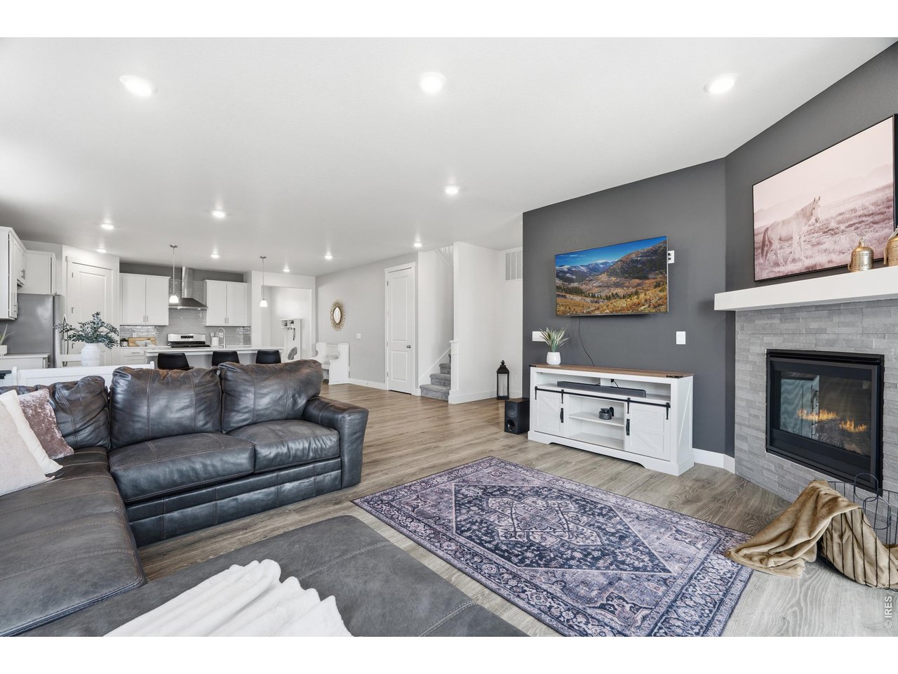 Property Photo 13 Large living room with stone accent fireplace.