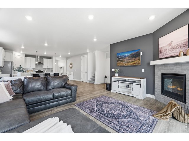 Property Photo 13 Large living room with stone accent fireplace.