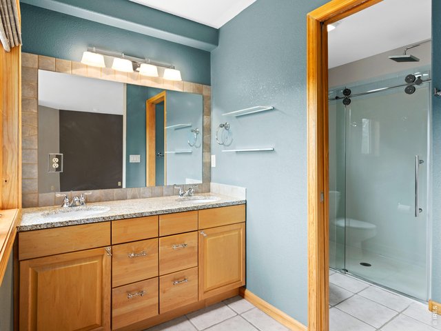 Property Photo 26 Full bathroom with large vanity and glass shower
