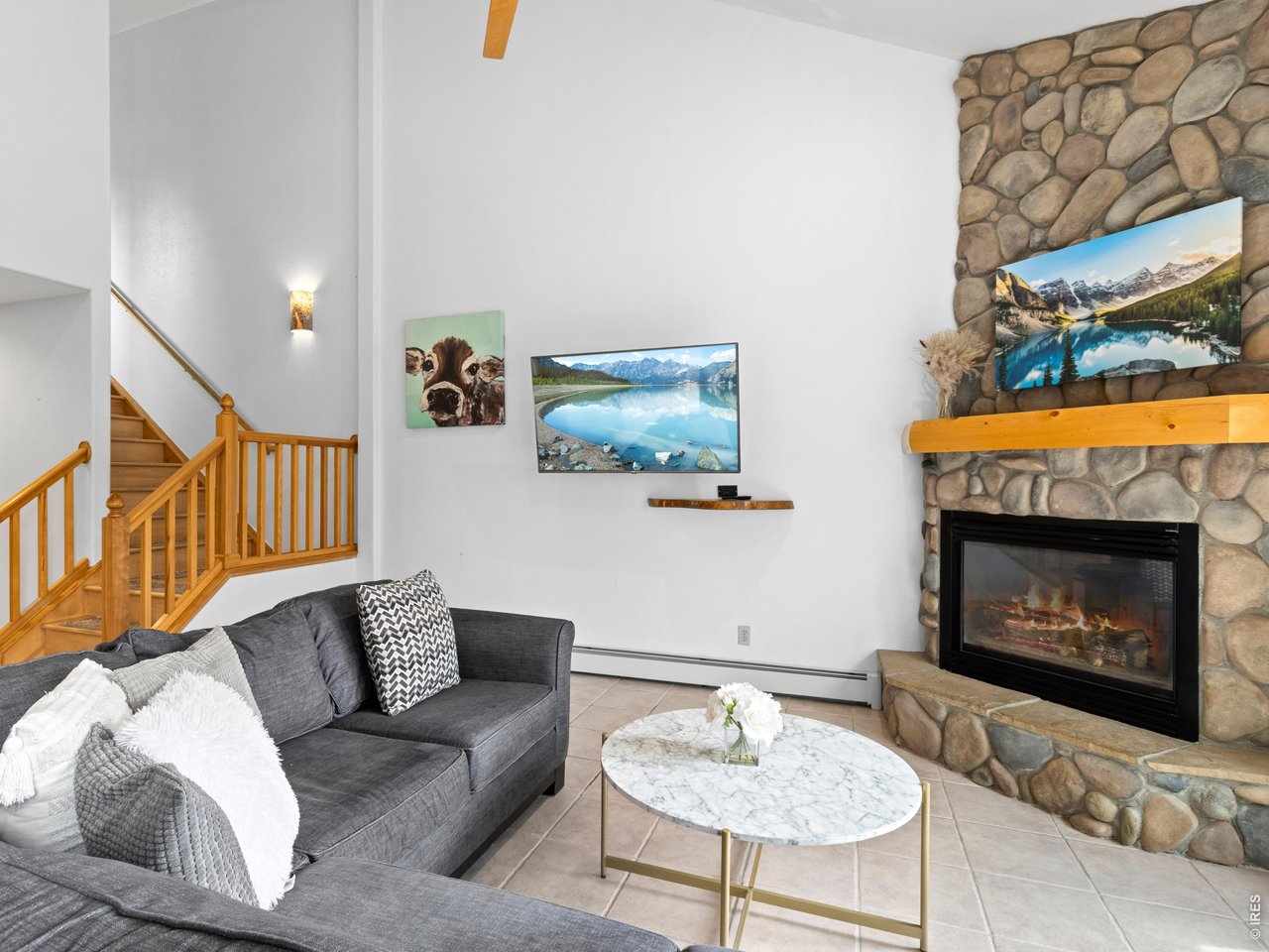 Property Photo 12 Bright living room with stone fireplace