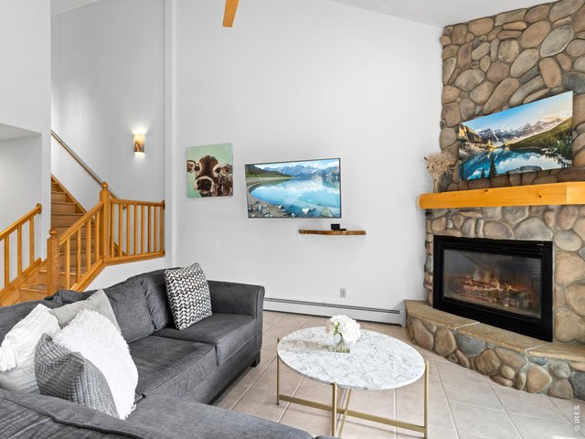 Property Photo 12 Bright living room with stone fireplace