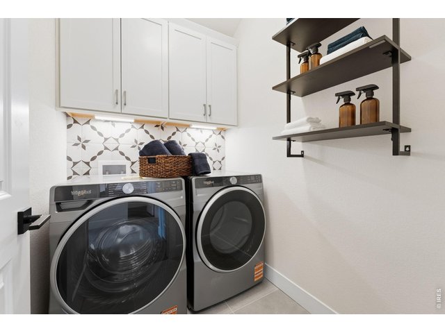Property Photo 27 Beautiful Walk-In Laundry Room with Modern Tile and Soft Close Cabentry