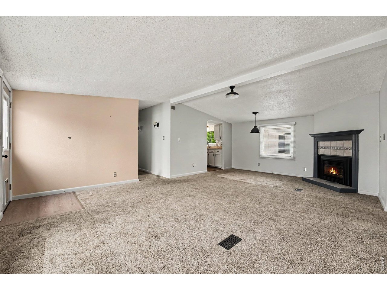 Property Photo 4 Large living room open to dining room with vaulted ceilings