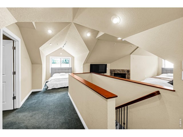 Property Photo 38 Unique upper-level loft with vaulted architectural ceilings, fireplace and flexible sleeping or recreation space.