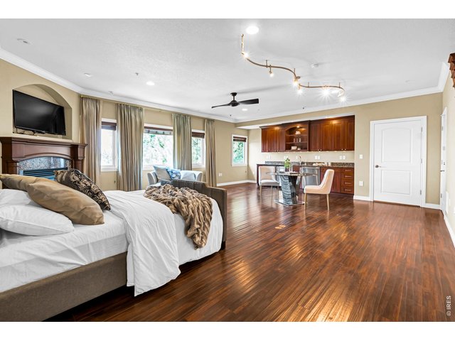 Property Photo 23 Spacious bonus room featuring a fireplace, nice floors, sitting area, private wet bar and convenient half bath.
