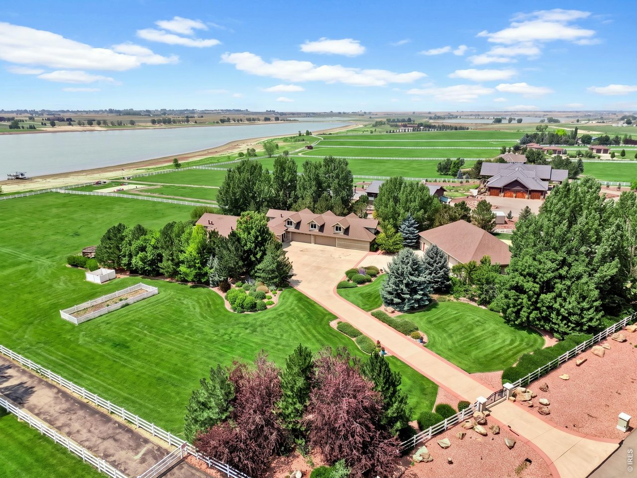 Property Photo 43 Aerial view of the property and surrounding reservoir. Grass color has been enhanced in professional photography.
